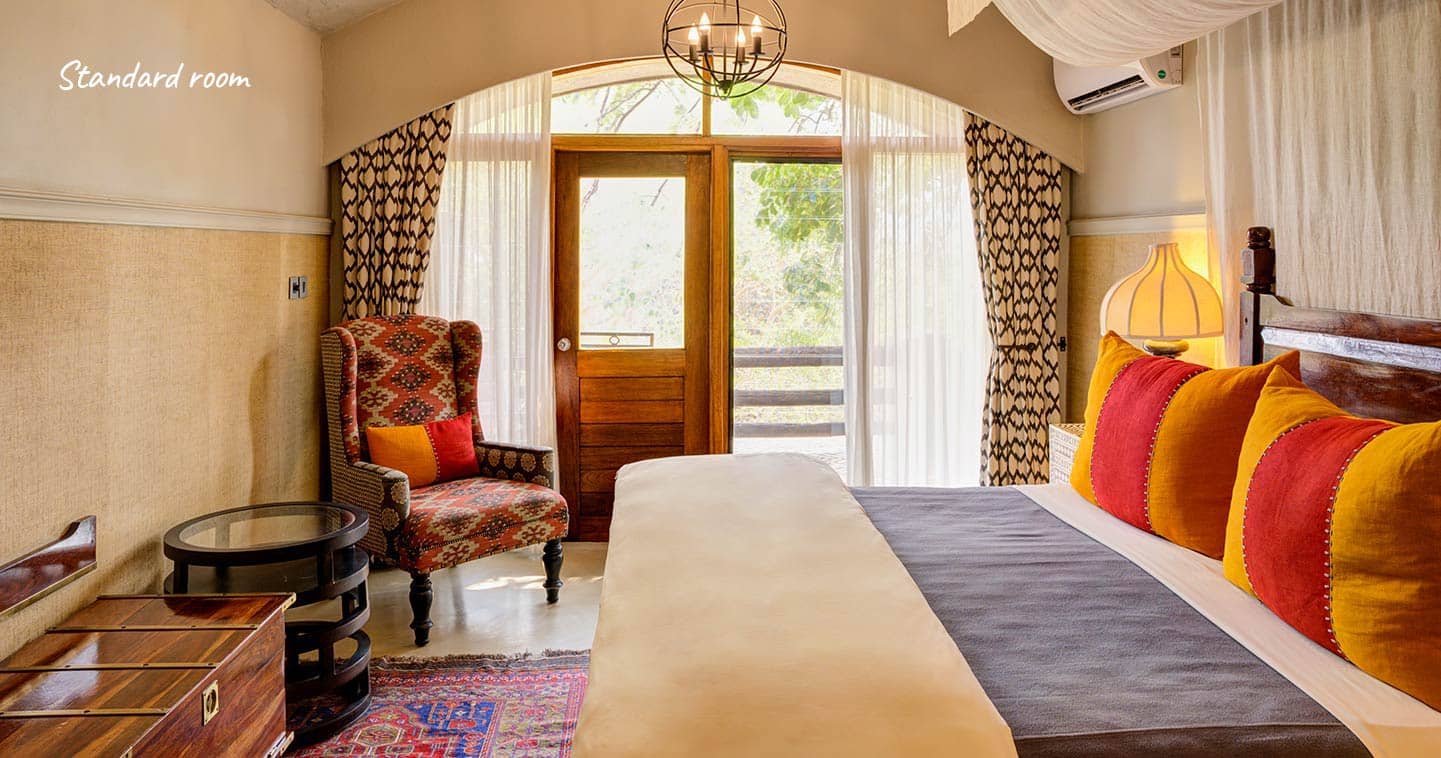 A standard room bedroom at Chobe Game Lodge